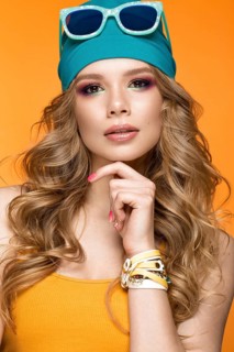 Bright cheerful girl in a sports hat