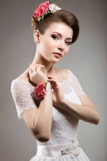 Portrait of a beautiful woman in the image of the bride with flowers in her hair. Picture taken in the studio on a black background