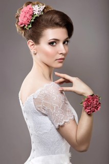 Portrait of a beautiful woman in the image of the bride with flowers in her hair. Picture taken in the studio on a black background