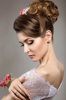 Portrait of a beautiful woman in the image of the bride with flowers in her hair. Picture taken in the studio on a black background