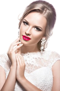 Portrait of a beautiful woman in a wedding dress in the image of the bride. Picture taken in the studio on a white background