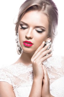 Portrait of a beautiful woman in a wedding dress in the image of the bride. Picture taken in the studio on a white background