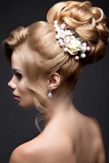 Portrait of a beautiful blond woman in the image of the bride. Picture taken in the studio on a black background. Beauty face and Hairstyle