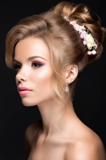 Portrait of a beautiful blond woman in the image of the bride. Picture taken in the studio on a black background. Beauty face and Hairstyle