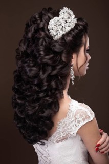 Beautiful brunette girl in the image of the Arab bride in a wedding dress and a crown on her head. Beauty face. Picture taken in the studio