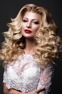 Beautiful blonde bride in wedding image with curls