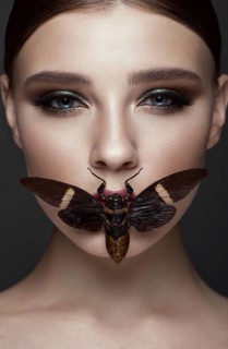 Portrait of beautiful girl with colorful make-up and cicada. Beauty face. Photo taken in the studio