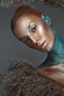 Portrait of a girl with gold and blue creative art make-up. Photo taken in the studio