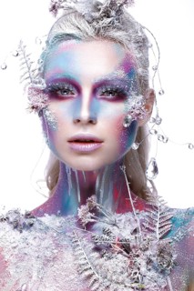 Beautiful girl in the image of a snowy unicorn creature. Creative make up. Art looks. Photo taken in the studio