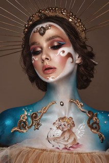 Portrait of a girl with gold and blue creative art make-up. Photo taken in the studio. Renaissance
