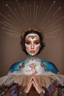 Portrait of a girl with gold and blue creative art make-up. Photo taken in the studio. Renaissance