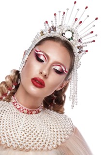 Beautiful woman in a creative style with bright makeup and white clothes and accessories
