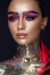 Beautiful girl with creative glitter makeup with sparkles