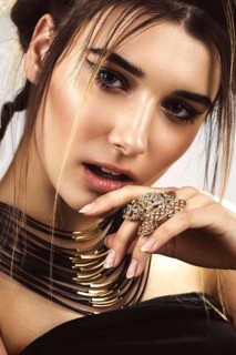 Beautiful fashion woman with creative make-up and hairstyle wearing glasses and jewelry. The beauty of the face. Photos shot in the studio