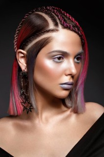 Beautiful girl with multi-colored hair and creative make-up and hairstyle. Beauty face. Photo taken in the studio