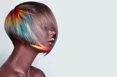Beautiful girl with multi-colored hair and creative make up and hairstyle. Beauty face. Photo taken in the studio