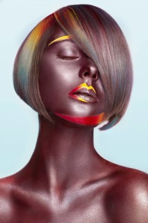 Beautiful girl with multi-colored hair and creative make up and hairstyle. Beauty face. Photo taken in the studio