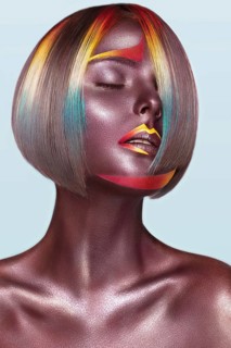 Beautiful girl with multi-colored hair and creative make up and hairstyle. Beauty face. Photo taken in the studio