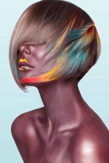 Beautiful girl with multi-colored hair and creative make up and hairstyle. Beauty face. Photo taken in the studio