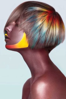 Beautiful girl with multi-colored hair and creative make up and hairstyle. Beauty face. Photo taken in the studio