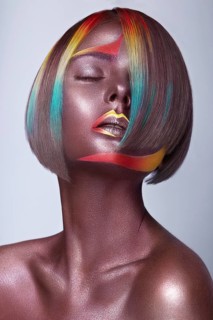 Beautiful girl with multi-colored hair and creative make up and hairstyle. Beauty face. Photo taken in the studio