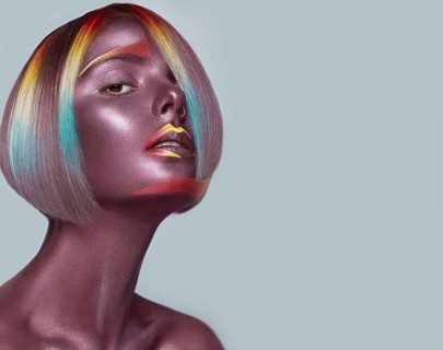 Beautiful girl with multi-colored hair and creative make up and hairstyle. Beauty face. Photo taken in the studio