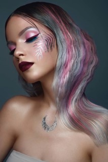 Beautiful girl with multi-colored hair and creative make up and hairstyle. Beauty face. Photo taken in the studio