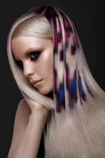 Portrait of beautiful woman with multi-colored hair and creative make up and hairstyle