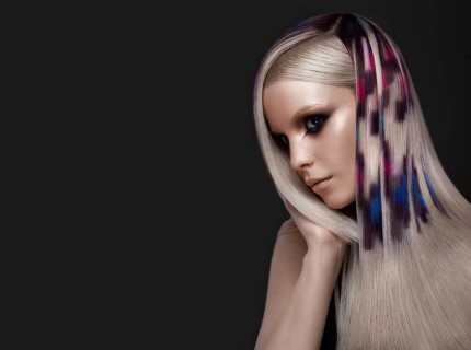 Portrait of beautiful woman with multi-colored hair and creative make up and hairstyle