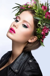 Portrait of a beautiful woman in the image of the bride with flowers in her hair. Picture taken in the studio on a black background