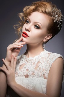 Portrait of a beautiful woman in the image of the bride with jewelry in her hair. Picture taken in the studio on a black background