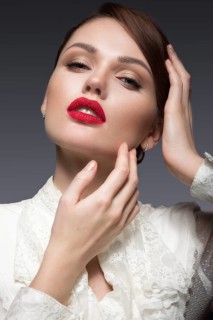 Beautiful girl with red lips in white clothes in the form of retro. Beauty face. Picture taken in the studio