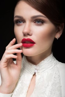 Beautiful girl with red lips in white clothes in the form of retro. Beauty face. Picture taken in the studio