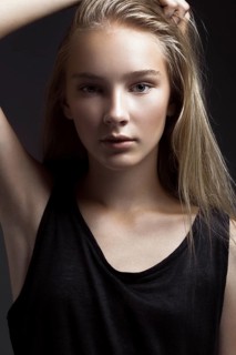 Fashion model is posing in studio for test photo shoot showing different poses