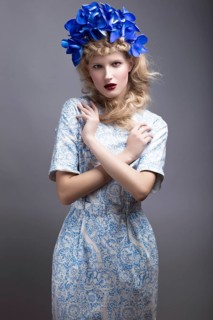 Girl with flowers on her head in a dress in the Russian style. Picture taken in the studio