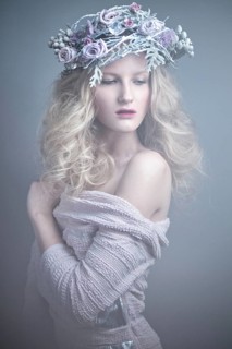 Girl with flowers on her head in a dress in the Russian style. Picture taken in the studio
