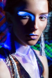 Fashion model beautiful girl in fashionable clothes in ultraviolet light