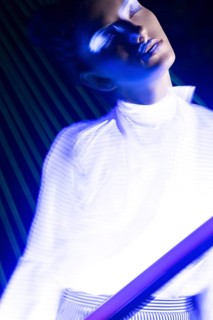 Fashion model beautiful girl in fashionable clothes in ultraviolet light