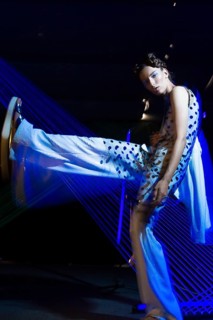 Fashion model beautiful girl in fashionable clothes in ultraviolet light