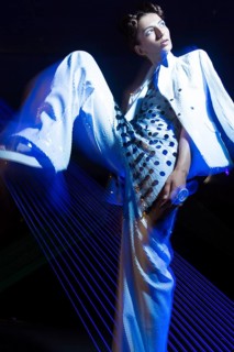 Fashion model beautiful girl in fashionable clothes in ultraviolet light