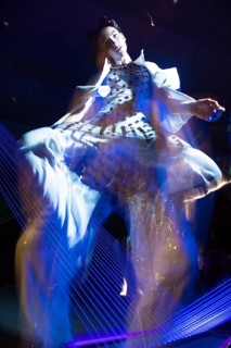 Fashion model beautiful girl in fashionable clothes in ultraviolet light