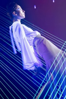 Fashion model beautiful girl in fashionable clothes in ultraviolet light