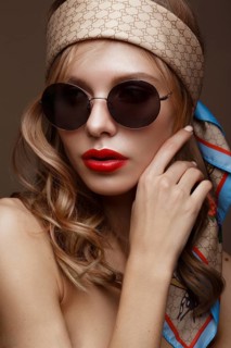 Beautiful girl in stylish clothes with sunglasses and red sexy lips. Beauty face. Photo taken in the studio