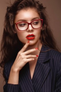 Beautiful girl in stylish clothes with glasses for vision. Beauty face. Photo taken in the studio