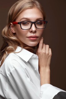 Beautiful girl in stylish clothes with glasses for vision and red sexy lips. Beauty face. Photo taken in the studio