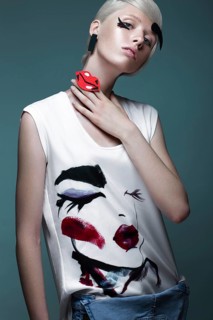 Fashionable girl with natural make-up in clothes with a picture in the style of pop art