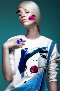 Fashionable girl with natural make-up in clothes with a picture in the style of pop art