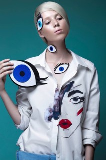 Fashionable girl with natural make-up in clothes with a picture in the style of pop art