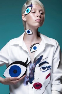 Fashionable girl with natural make-up in clothes with a picture in the style of pop art