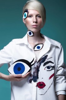 Fashionable girl with natural make-up in clothes with a picture in the style of pop art